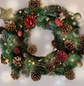 Golden and red colored pine cones in a Christmas wreath