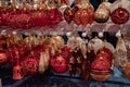 Golden and red glass baubles Christmas ornaments are hanging on shelves at Christmas market in Europe. Holiday decorations. Royalty Free Stock Photo