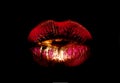 Golden red lips. Woman mouth icon. Lips isolated on black background. Luxury cosmetics concept. Smile or kiss. Royalty Free Stock Photo