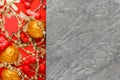 Golden and red New Year tree toys on grey stone background with copyspace. Christmas composition Royalty Free Stock Photo