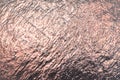 Golden reflective texture for background. Sheet of foil surface scratches and dark shadows Royalty Free Stock Photo