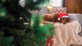 A Golden Retriever dog wearing a Santa hat, lying on the sofa. Christmas dog. Royalty Free Stock Photo