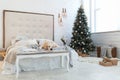 Golden retriever puppy dog nap on white fur coat near Christmas tree Royalty Free Stock Photo