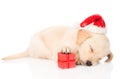 Golden retriever puppy dog with santa hat and gift. Royalty Free Stock Photo