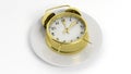 Golden retro alarm clock on a plate