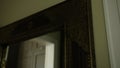 Golden retro mirror frame, close up. Creative. Vintage interior with a mirror in a beautiful frame. Royalty Free Stock Photo