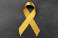 Golden ribbon on dark background. Children cancer