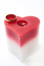 Golden ring and candle in the heart shape Royalty Free Stock Photo