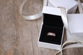 Golden ring with dimonds in white gift box