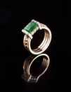 Golden ring with emerald diamond brilliant