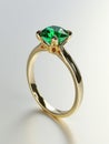 Golden ring with green emerald gemstone. Royalty Free Stock Photo