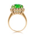 Golden ring with large emerald and cubic zirconias isolated
