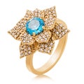 Golden ring with large topaz and small cubic zirconias, isolated