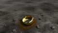 The golden ring lies among the stones on the gray earth. The lost ring lies on the dirty ground. Generated AI.