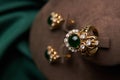 Golden ring and pair of earrings with green Emerald and Diamonds