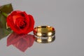 Golden Ring And Red Rose On Black Glass Royalty Free Stock Photo