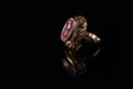 Golden ring with a ruby on a black background Royalty Free Stock Photo