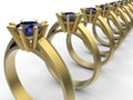 Golden rings array with blue topaz Royalty Free Stock Photo