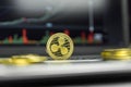 Golden Ripple coin with gold coins lying around on a black keyboard of silver laptop and diagram chart graph on a screen Royalty Free Stock Photo