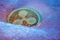 Golden Ripple coin, online digital currency frozen in the blue ice. Concept of block chain, market crash. Frozen crypto money,