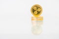 Golden Ripple coin with reflection on the table, online digital currency. Concept of block chain, market uprise