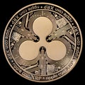 Golden Ripple XRP coin isolated on black background