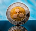 Golden Ripple XRP golden cryptocurrency coin lying on a dark  background with copy space. Royalty Free Stock Photo