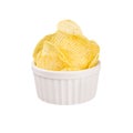 Golden rippled potatoes chips with spice in white ceramics bowl isolated on white background.