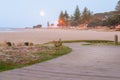 Golden rising moon over Mount Maunganui Main Beach