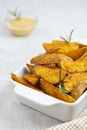 Golden roasted potatoes, bright food photo. Fried potatoes slices with sauce
