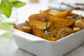 Golden roasted potatoes, bright food photo. Fried potatoes slices with sauce