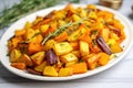 golden roasted root vegetables on white plate