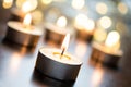 Golden Romantic Tealights In Bright Christmas Atmosphere On Wooden Table With Bokeh - Crooked Angle