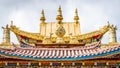 Golden roof details with Dharma wheel of Baiji or one hundred chicken Tibetan Buddhist temple Shangri-La Yunnan China Royalty Free Stock Photo