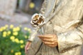 Golden rose as a symbol in the hands of a person painted with gold paint Royalty Free Stock Photo