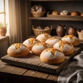 Golden, round loaves of bread rest on a rustic wooden board inside a cozy kitchen. Royalty Free Stock Photo