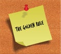 THE GOLDEN RULE handwritten on yellow sticky paper note over cork noticeboard background.