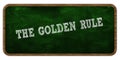 THE GOLDEN RULE written with chalk on green chalkboard. Wooden frame.