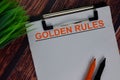 Golden Rules text write on a paperwork isolated on office desk