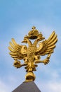 Golden Russian coat of arms on a blue sky background