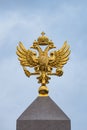 Golden Russian coat of arms on a blue sky background