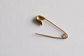 Golden safety pin on white background, top view Royalty Free Stock Photo