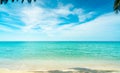 Golden sand beach by the sea with emerald green sea water and blue sky and white clouds. Summer vacation on tropical paradise Royalty Free Stock Photo