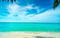 Golden sand beach by the sea with emerald green sea water and blue sky and white clouds. Summer vacation on tropical paradise Royalty Free Stock Photo