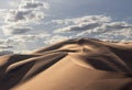 Golden sand dune 7 and white clouds on a sunny day in the Namib desert Royalty Free Stock Photo