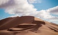 Golden sand dune 7 and white clouds on a sunny day Royalty Free Stock Photo