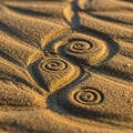 Golden sand forms intricate spiral patterns, casting soft shadows on the surface. The spirals Royalty Free Stock Photo