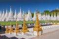 Golden Sandamuni Pagoda with row of white pagodas. Amazing architecture of Buddhist Temples at Mandalay, Myanmar Royalty Free Stock Photo