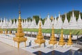 Golden Sandamuni Pagoda with row of white pagodas. Amazing architecture of Buddhist Temples at Mandalay, Myanmar Burma Royalty Free Stock Photo