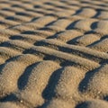 Golden sandy beach surface with wavy, textured patterns created by wind or water Royalty Free Stock Photo